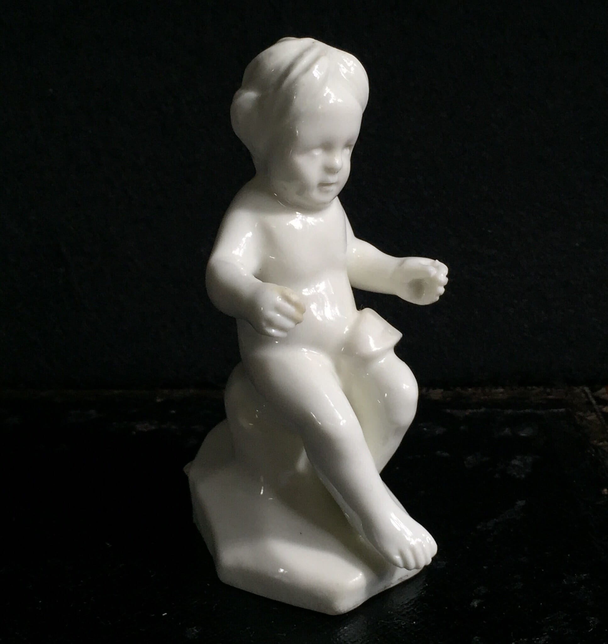 Orleans white porcelain figure of a seated boy, c. 1760 -0
