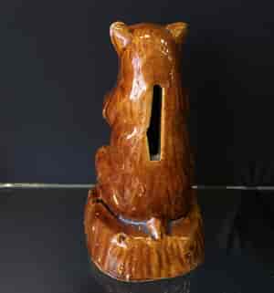 Bear shaped brown glazed pottery money box, 19th C. -23860