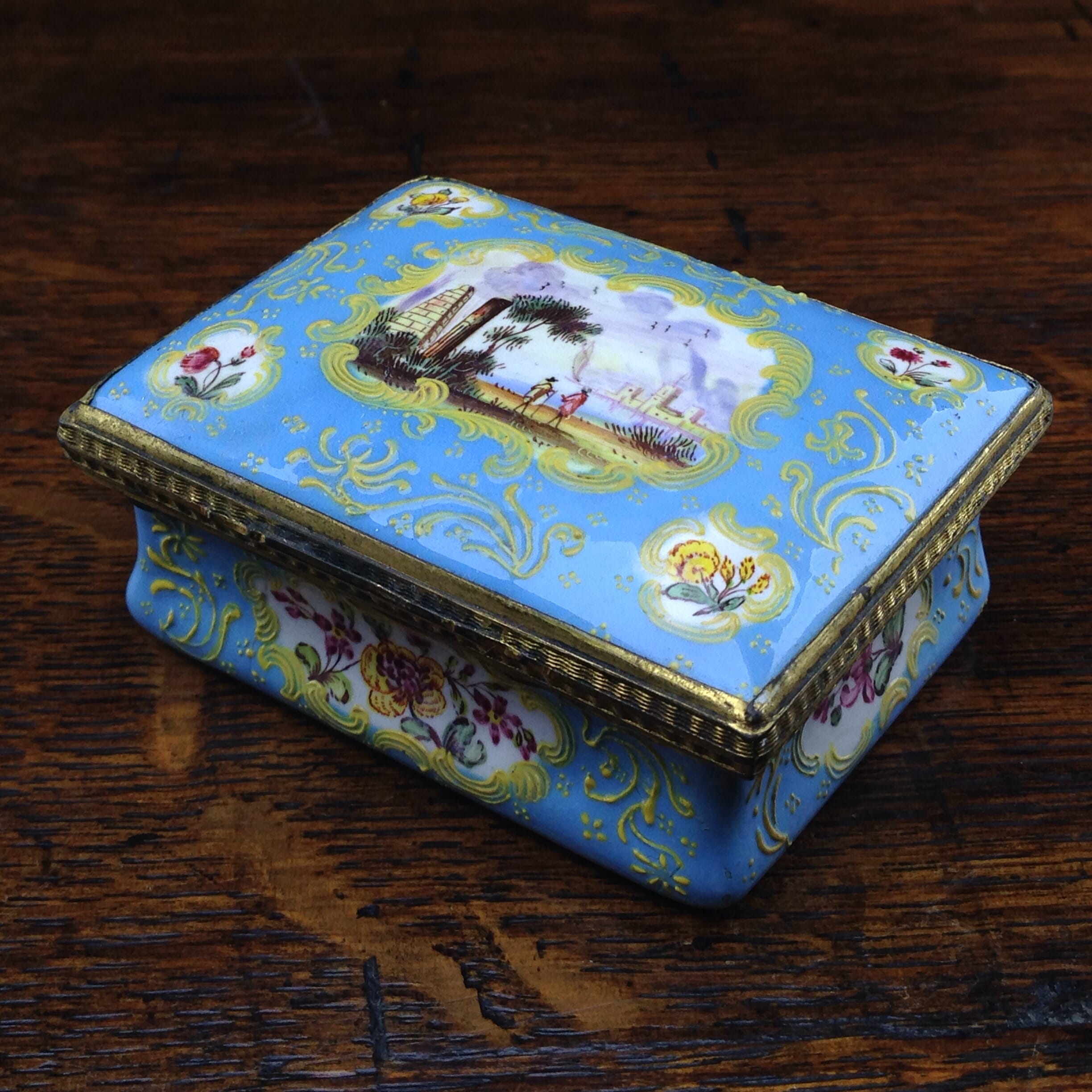 South Staffordshire enamel snuff box, pale blue ground with panels of scenes and flowers, c.1765 -0