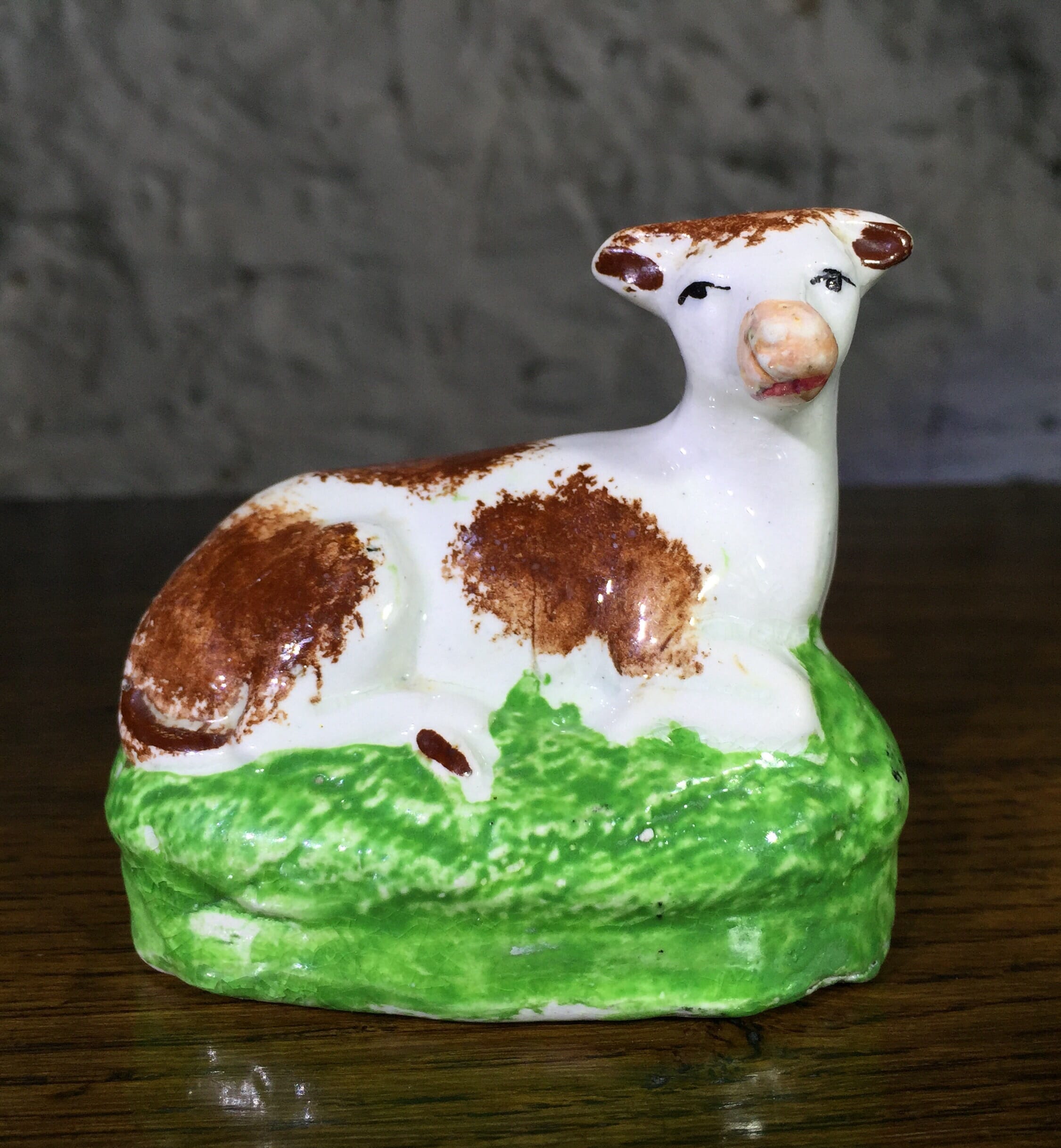 Staffordshire pottery seated cow, c. 1825-0