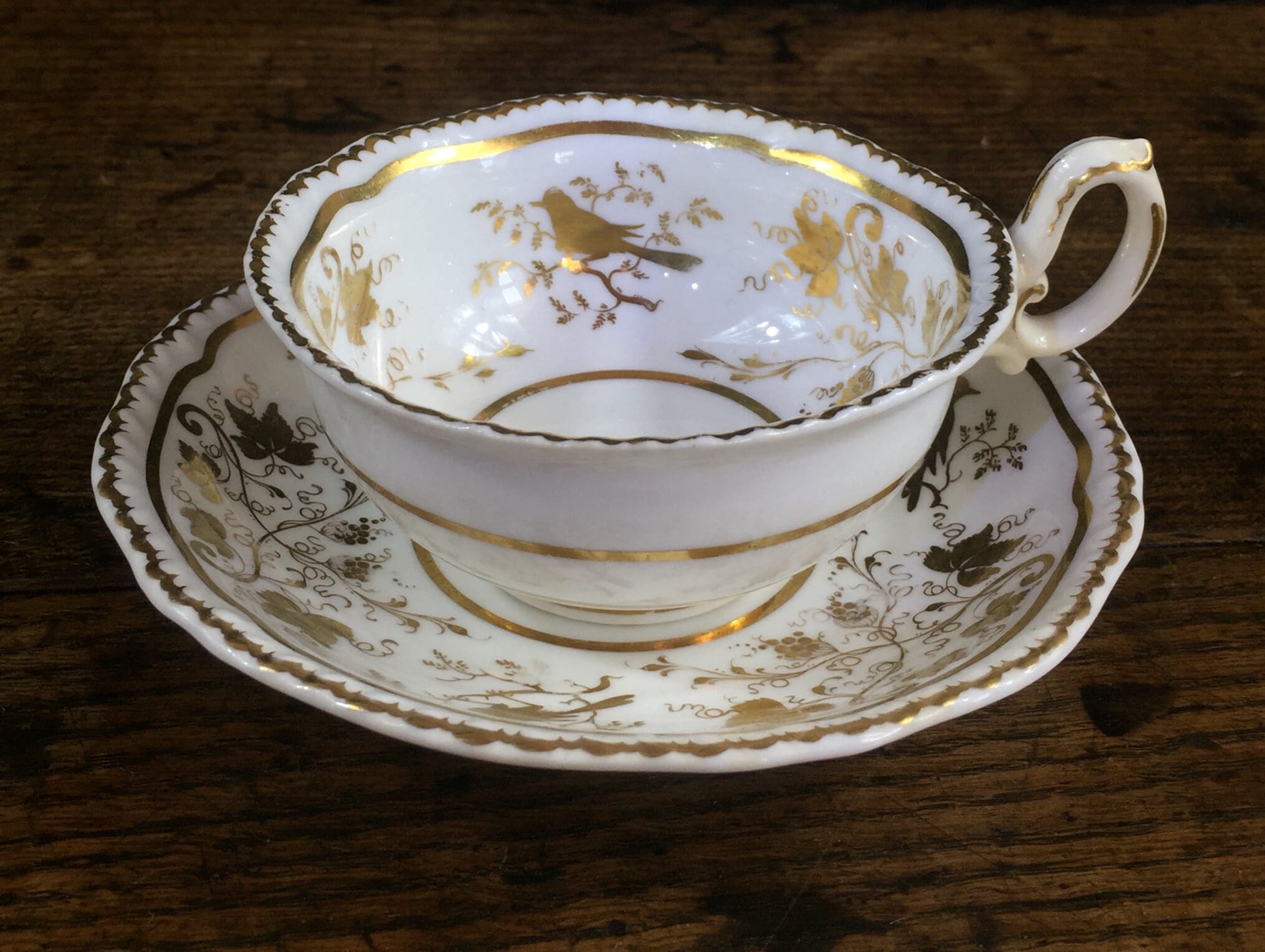 Granger Worcester cup and saucer with gilt bird and grape decoration c. 1830-0