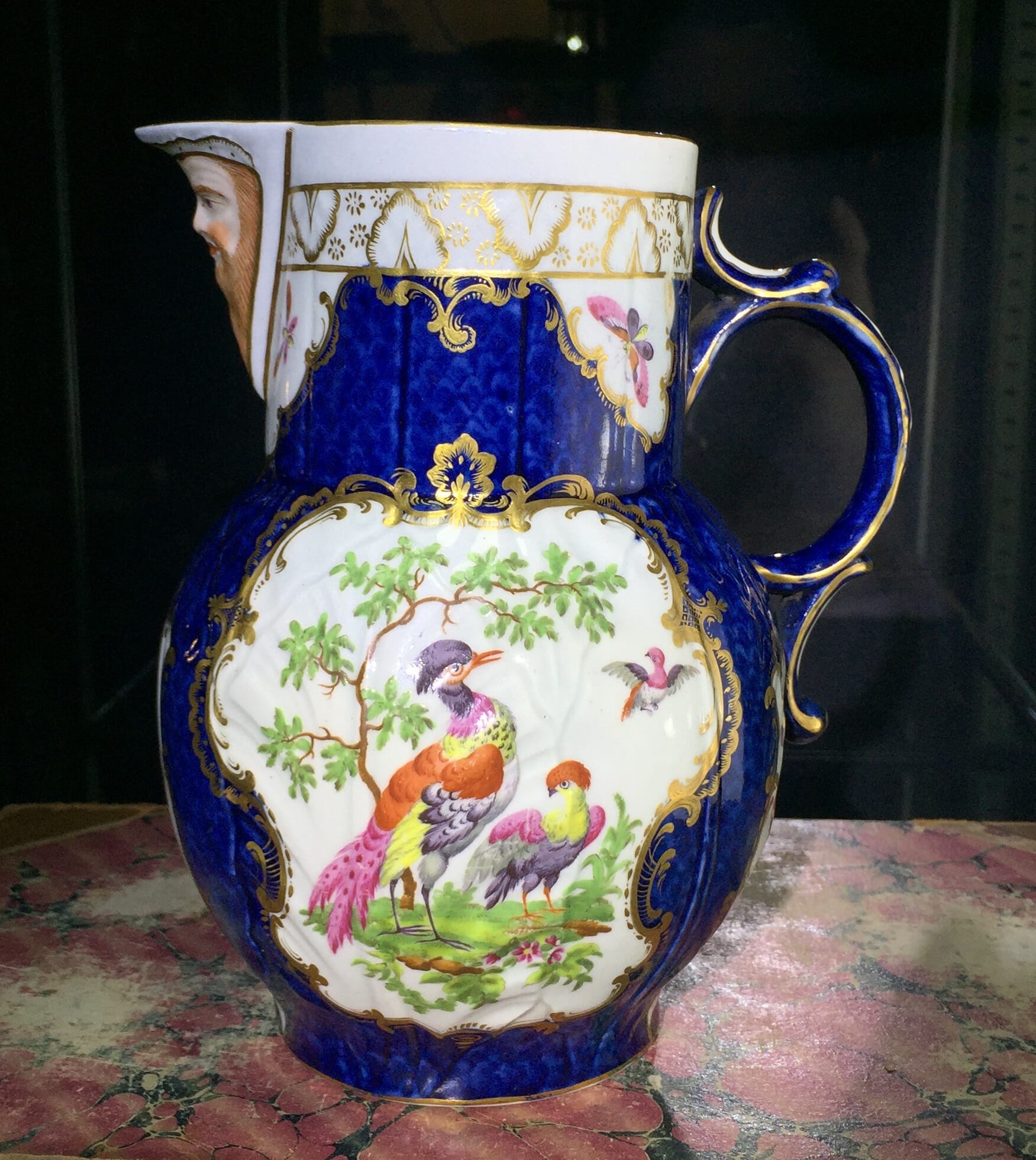 Worcester mask jug with scale blue ground, exotic birds, c. 1775-0