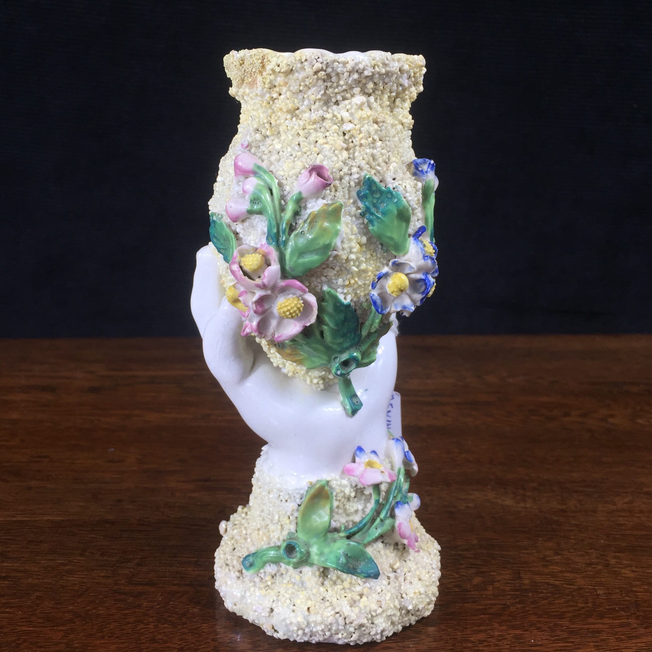 Bevington porcelain vase moulded as a hand holding a pot with applied flowers. c. 1880-0