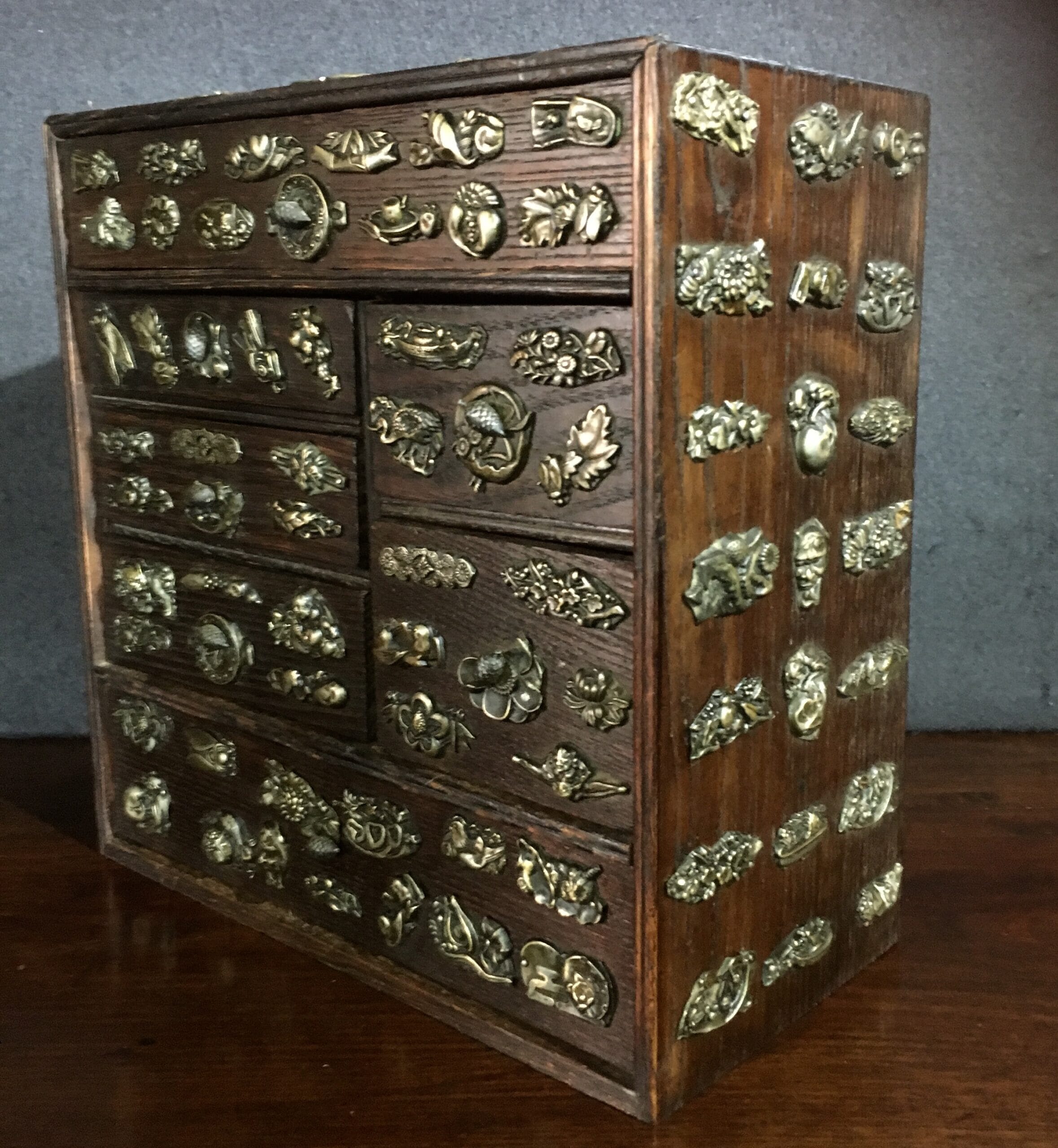 Small Japanese elm chest of drawers with brass appliqué motives, c.1890-0