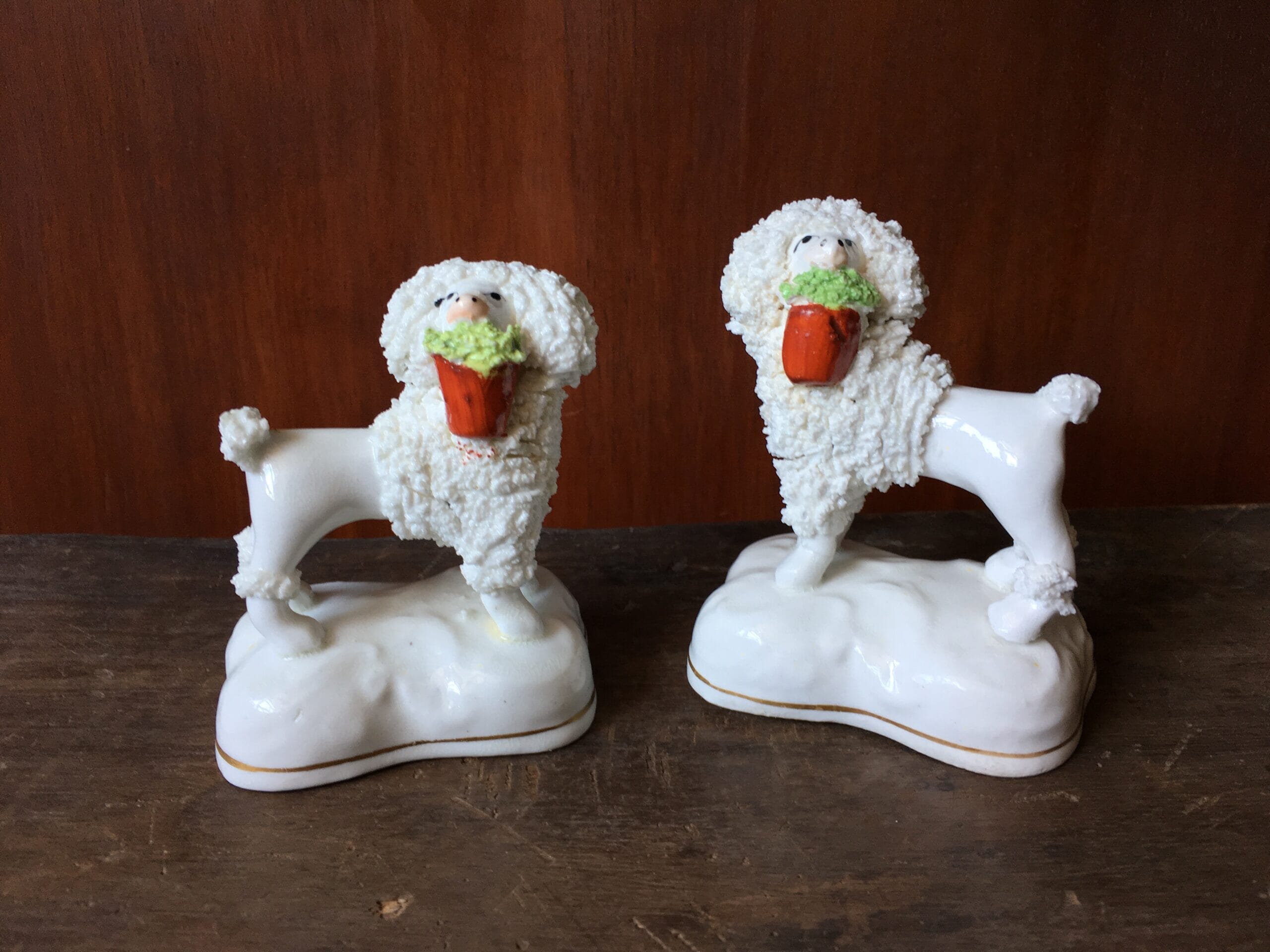 Pair of Staffordshire porcelain poodle dogs with baskets, c. 1835-0