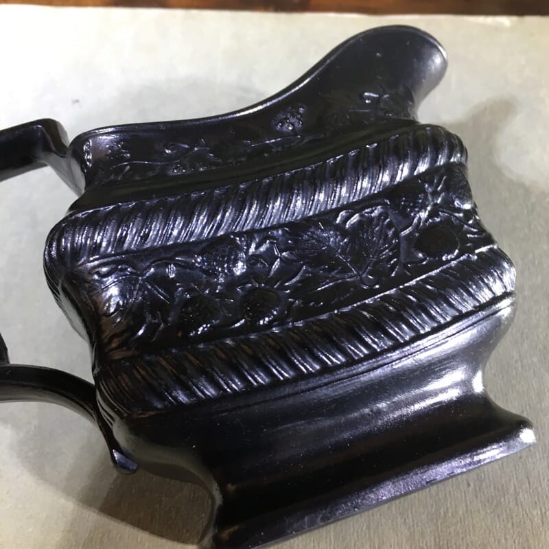 Black Basalt milk jug, strawberry moulded, c. 1820. -31086