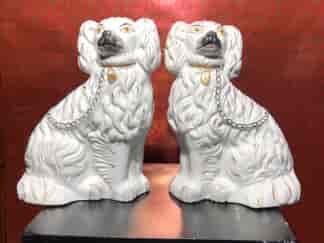 Pair of Staffordshire spaniels, white with fine moulding, c. 1875. -0