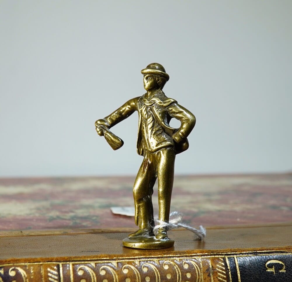 Brass pipe tamper, dandy with a bag, a Dickens character?  mid 19th century