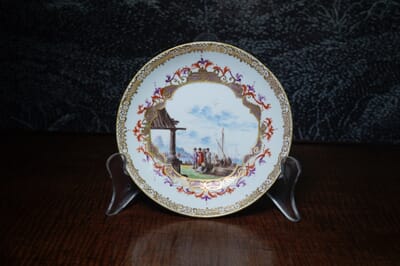 Meissen saucer with harbour scene, elaborate cartouche & Böttger