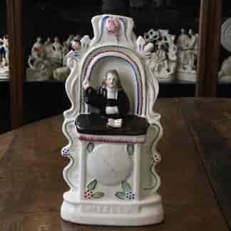 Staffordshire figure of Wesley, preaching from pulpit, clock face below, c.1865