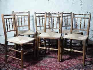 Set of 6 country elm chairs, spindle turned backs & rush seats, c.1820.