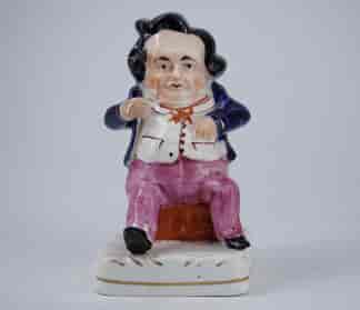 Staffordshire porcelain comical seated figure, c. 1850
