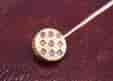 French 18k gold stick pin with 9 diamonds on a patterned disc, c.1900