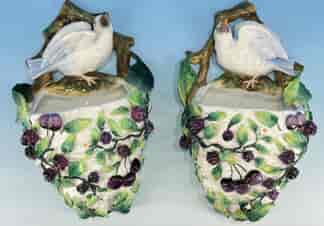 Pair of Continental wall pockets, birds on nest of berries, c.1870