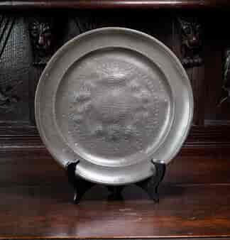 Pewter plate engraved with a detailed coat of arms, 18th c.