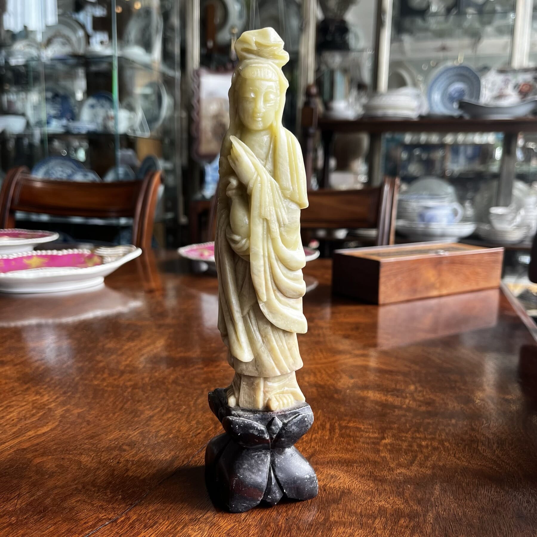 Soapstone Guanyin figure on dark stone lotus stand, early 20th c.