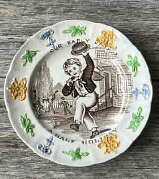 Child's pottery plate titled ’Our early days - A HALF HOLIDAY' c.1845