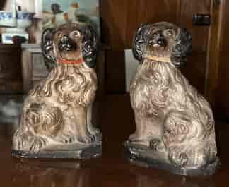 Chalkware pair of staffordshire style spaniels with red & beige collars, c.1880