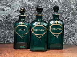 Three Georgian Emerald Green decanters, gilt labels, c.1800