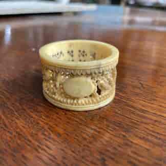 Chinese carved ivory serviette ring, figures in garden, 19th c.