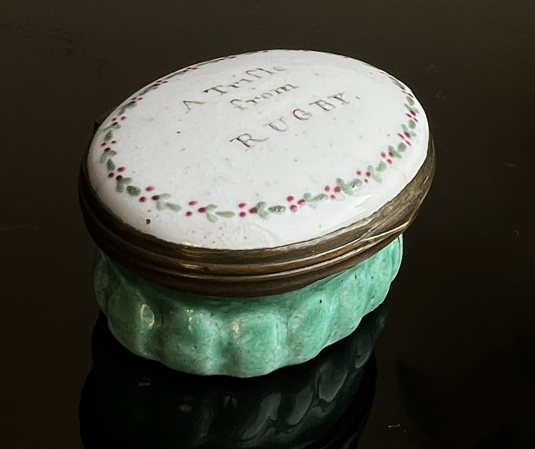 English enamel patch box, 'Trifle from Rugby' with green base, c. 1800