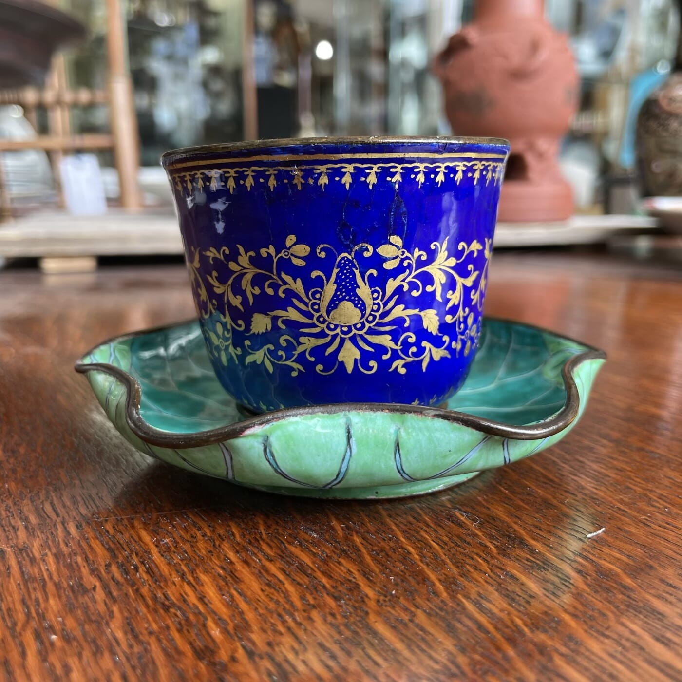 Chinese enamel cup in lotus leaf stand, 18th century