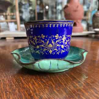 Chinese enamel cup in lotus leaf stand, 18th century