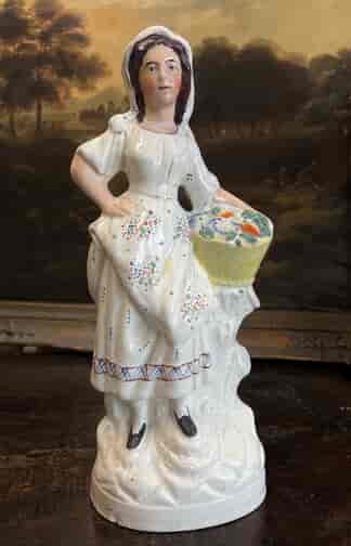 Large Staffordshire figure, Girl with basket of flowers, c. 1870
