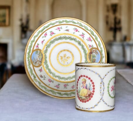 Sèvres coffee can & saucer, scenic panels by Jean Bouchet, dated 1781