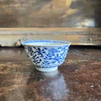 Kanxi moulded tea bowl, underglaze flower garden, rabbit mark c. 1720