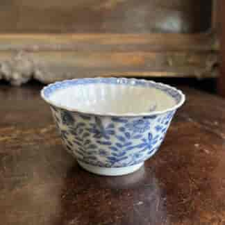 Kanxi moulded tea bowl, underglaze flower garden, rabbit mark c. 1720