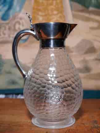 Glass claret jug with silver handle and spout, C.1885