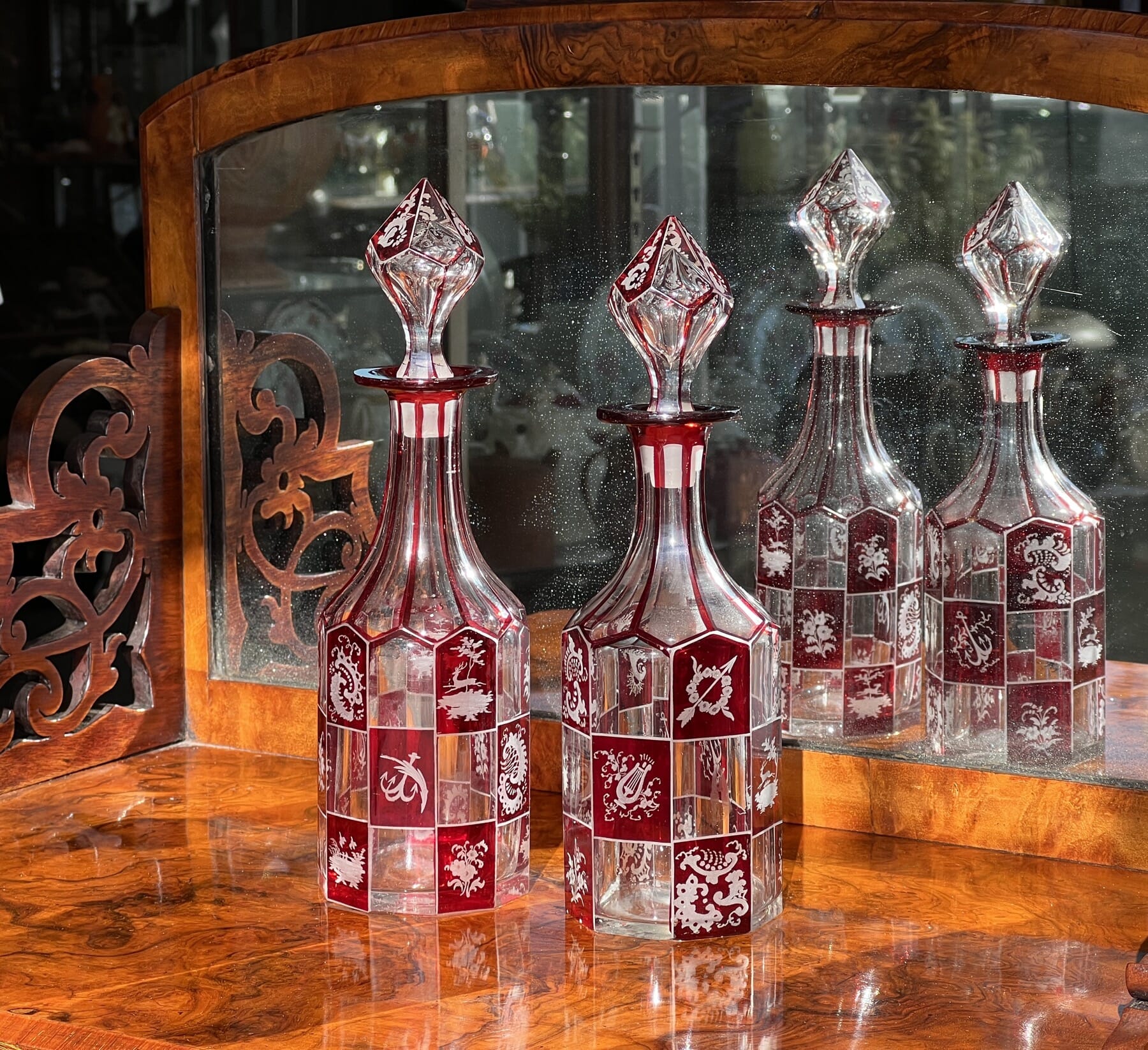Pair of Bohemian ruby engraved perfume decanters, circa 1870