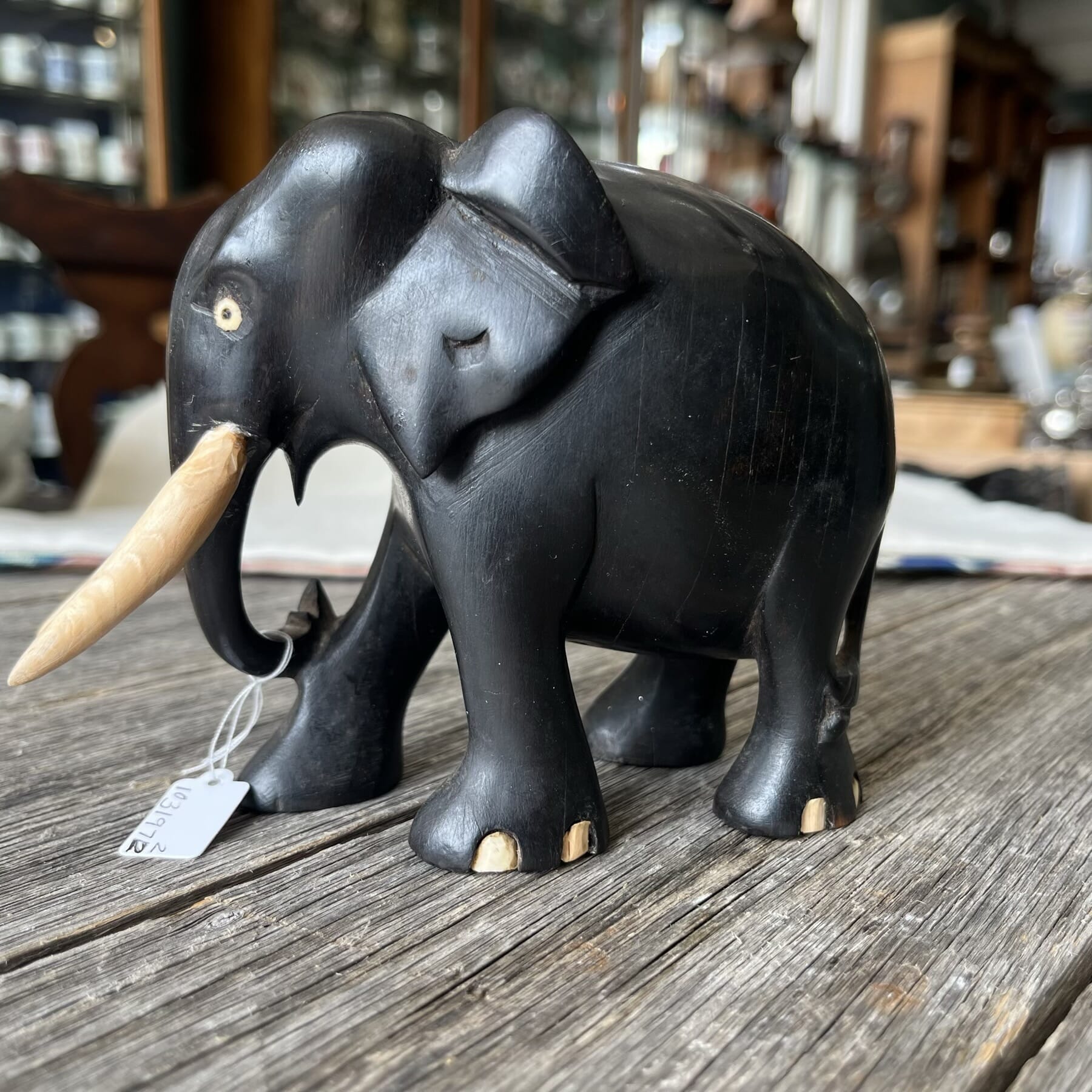 Ceylonese carved ebony elephant, with bone tusks Early 20th Ceylonese carved ebony elephant, with bone tusks Early 20th