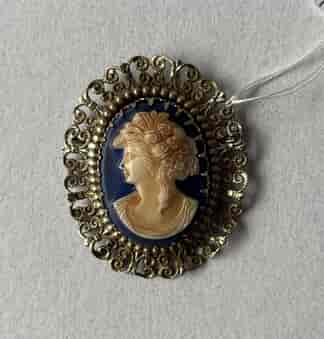 Glass cameo brooch with pressed metal mount. C.1920