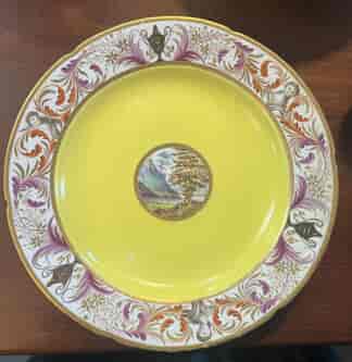 Coalport plate, London decorated with scene, yellow ground, classical busts, c.1805
