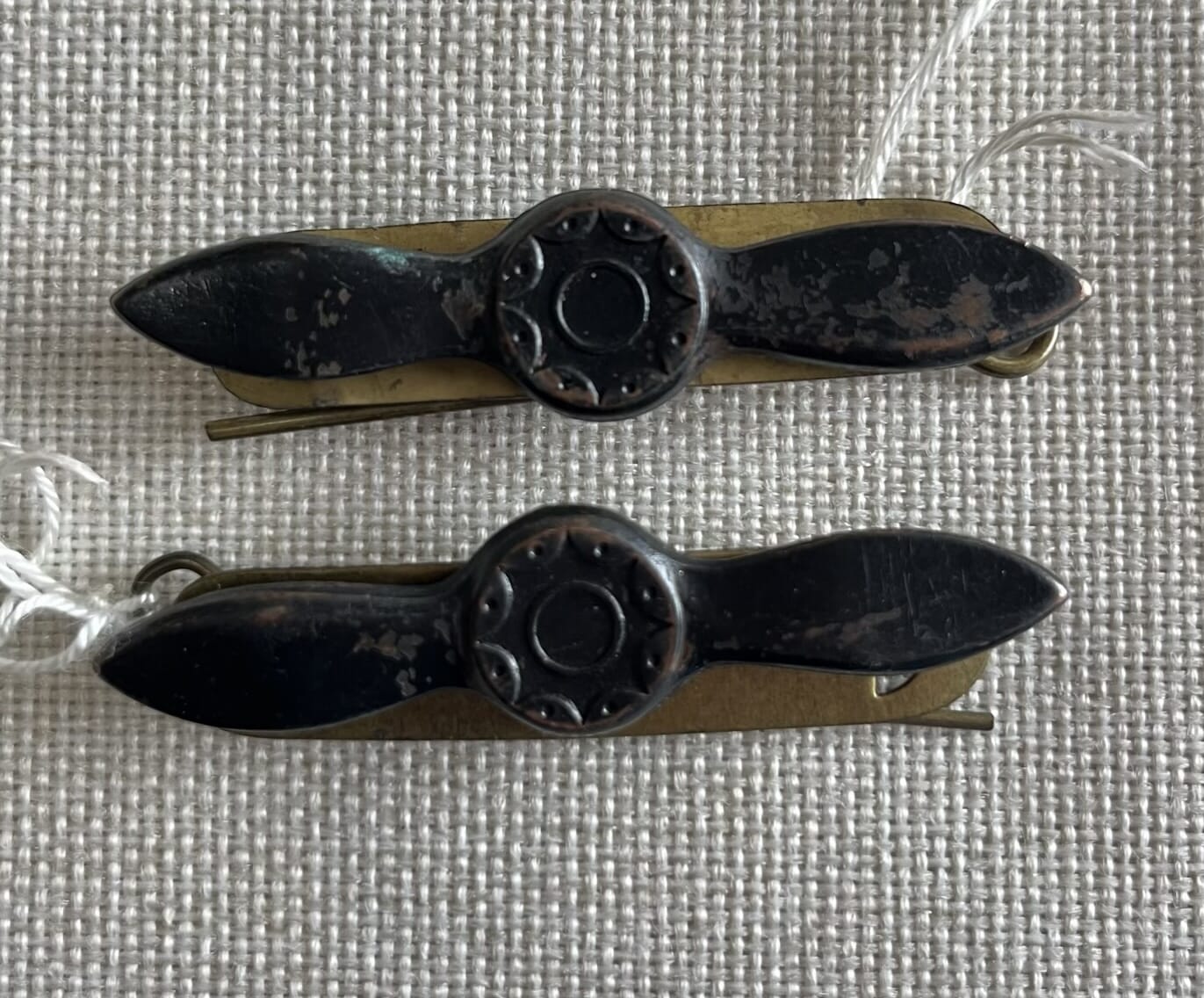 Pair of brass RAAF WW2 propeller uniform badges, c. 1940
