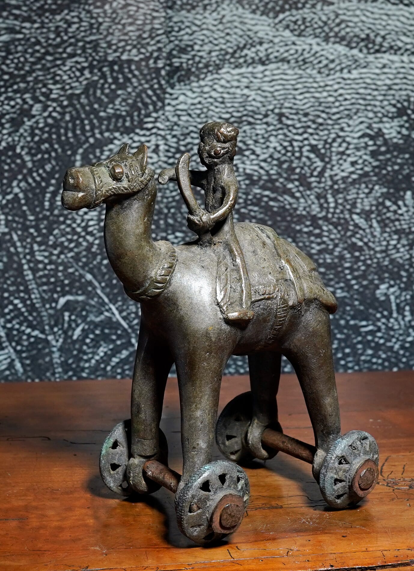 Indian Bronze Dhokra toy camel & rider on wheels, 19th/ earlier 20th century