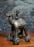 Indian Bronze Dhokra toy camel & rider on wheels, 19th/ earlier 20th century