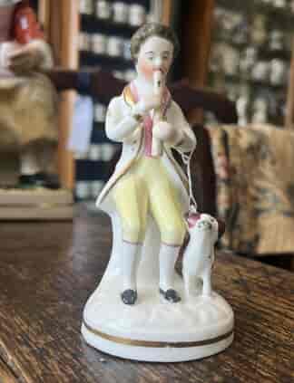 Staffordshire porcelain man playing an instrument  and dog, c. 1830