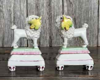 Pair of ‘naughty poodles’ with birds, on angular bases, c. 1835