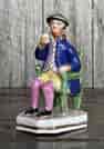 English Porcelain figure of 'Johnny Souter', seated with a drink, c. 1840