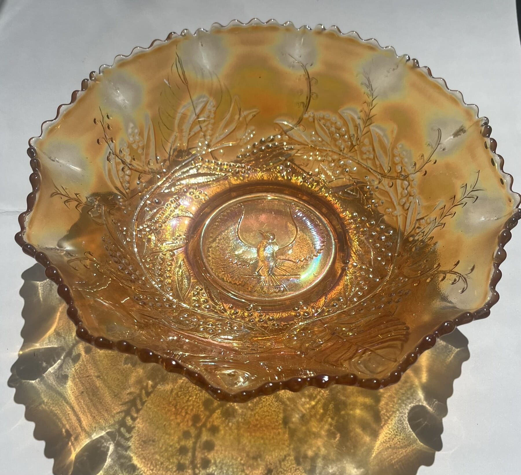 Large carnival marigold glass bowl, piping shrike bird C.1900