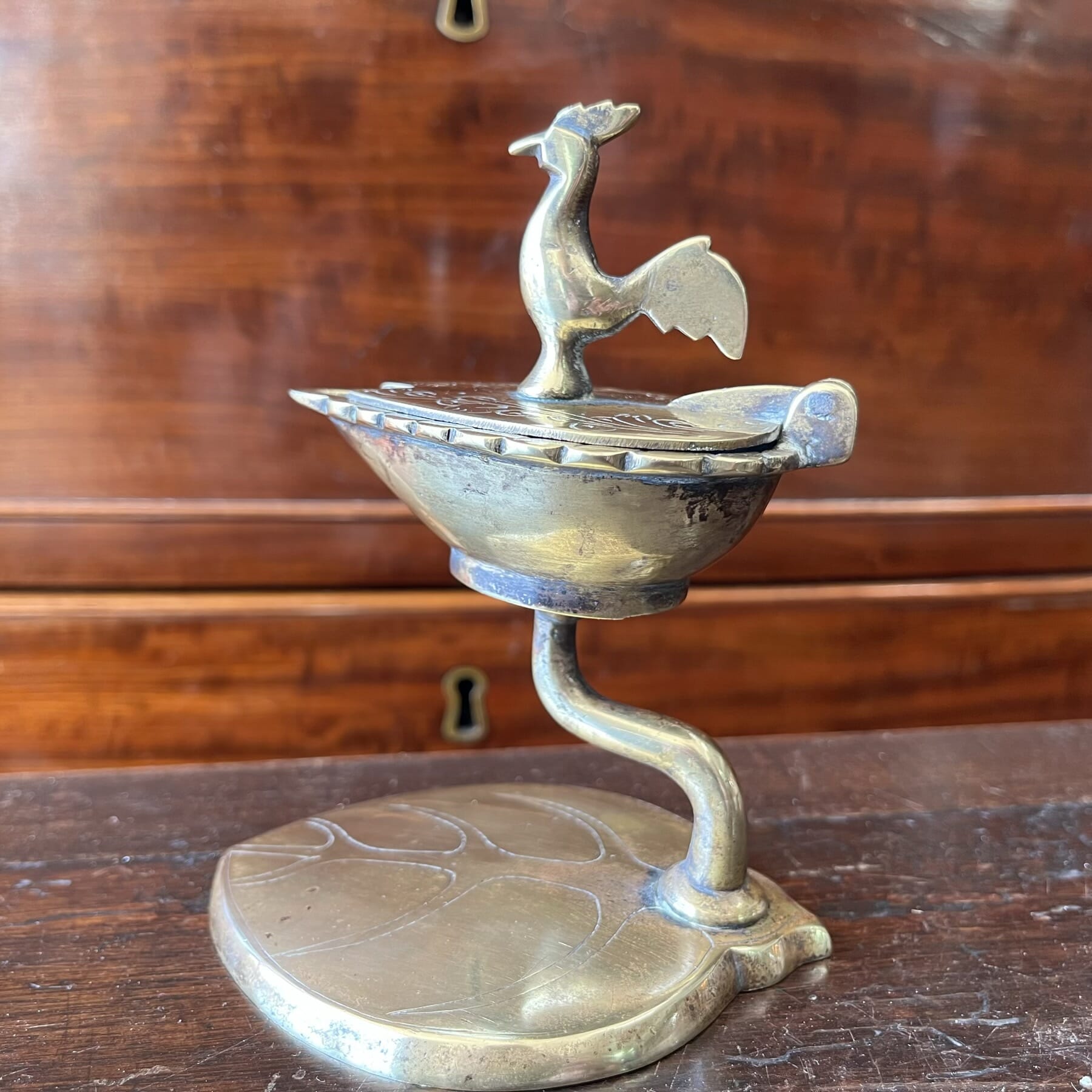 Indian brass Temple oil lamp on leaf-form stand, bird knop, Ceylon c. 1920