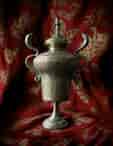 Flamboyant Indian Brass urn with lid, incised animals + figures, cobra handles, Devi knop, c. 1900