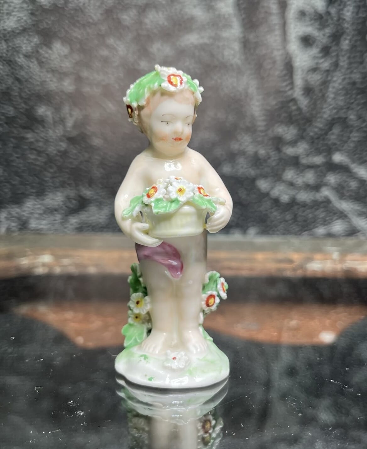 Derby figure of a boy, standing holding a basket of flowers C 1785