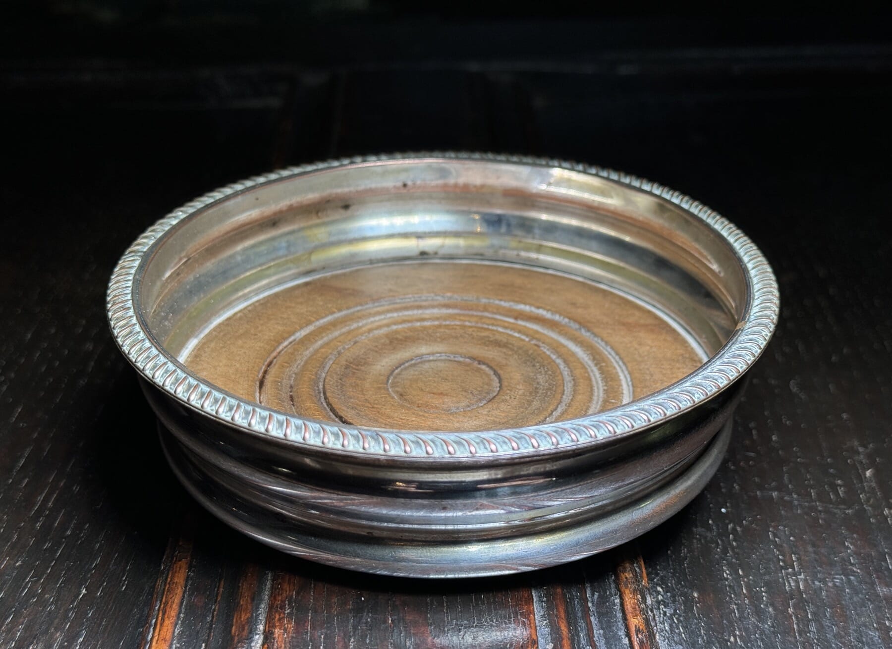 Victorian silverplate wine coaster with oak base, 19th century.