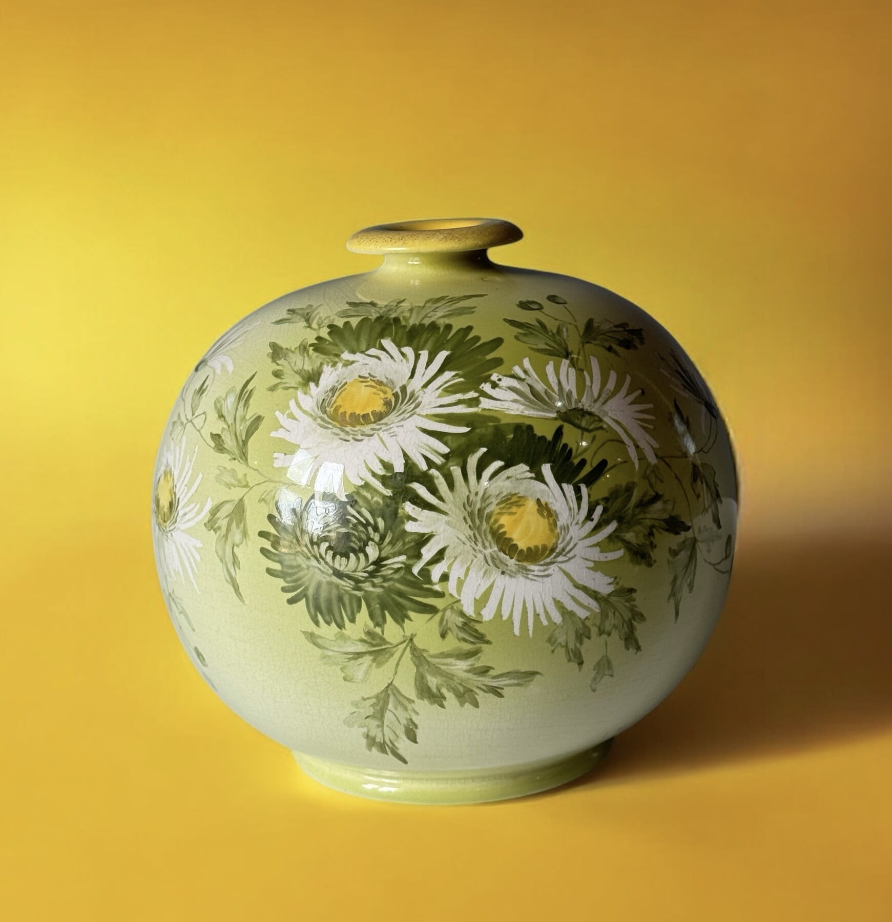 Art Pottery globular vase with hand-painted daisies on pale green, c.1885