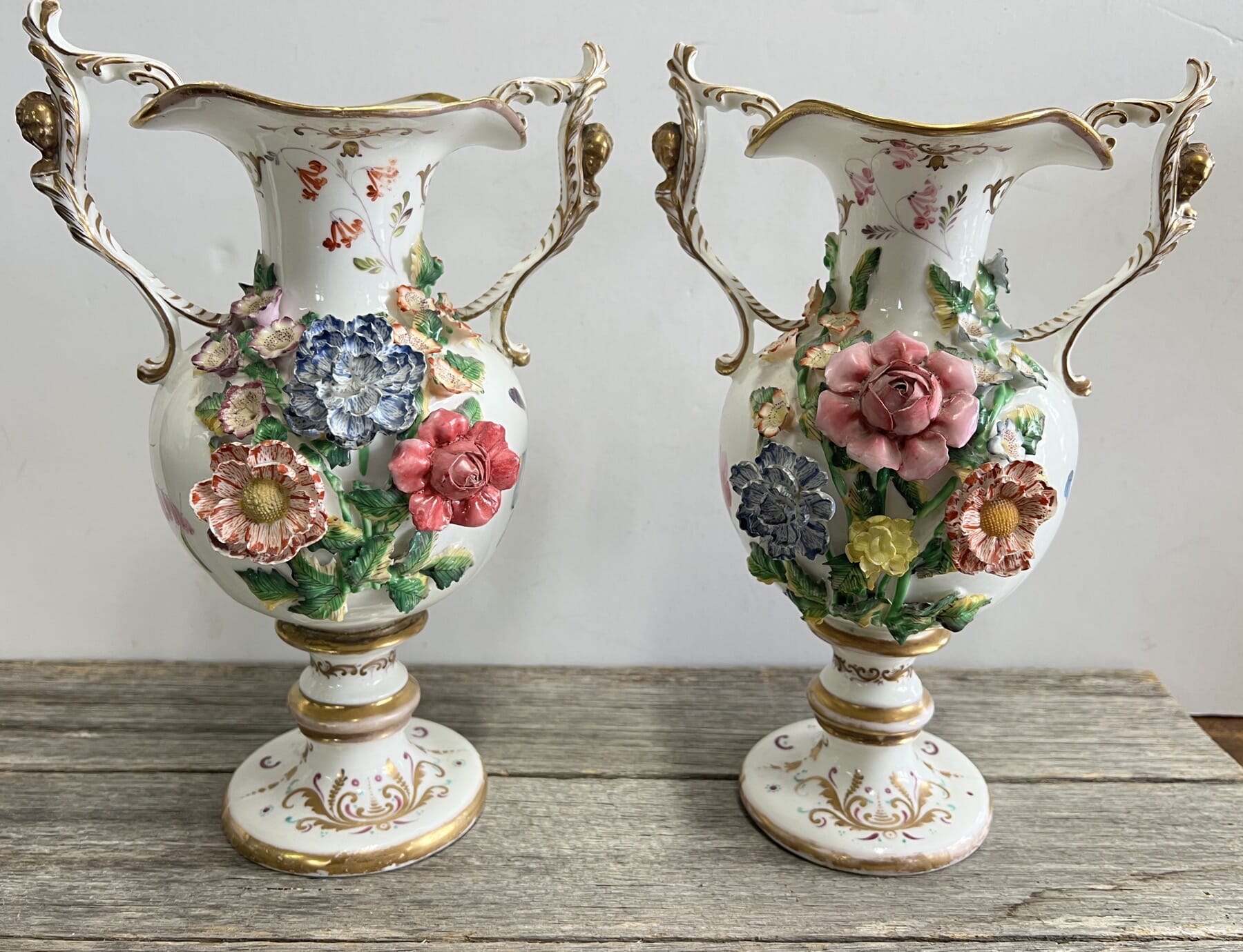 Pair of remarkable flower encrusted vases with gilt siren heads to the handles, poss. Davenport, c. 1830